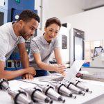 image showing workers over prototypes trying to answer what is cnc machining