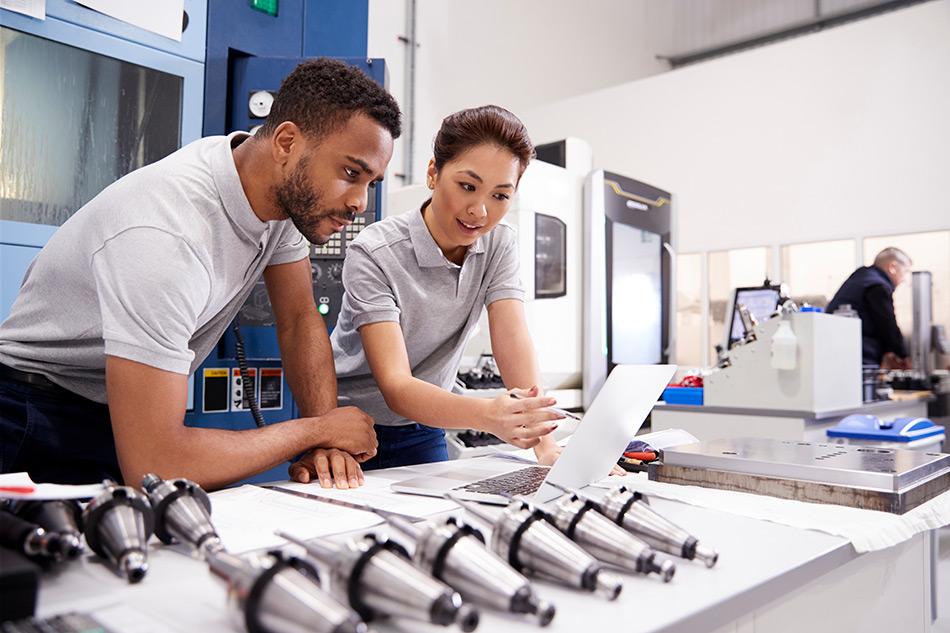 image showing workers over prototypes trying to answer what is cnc machining