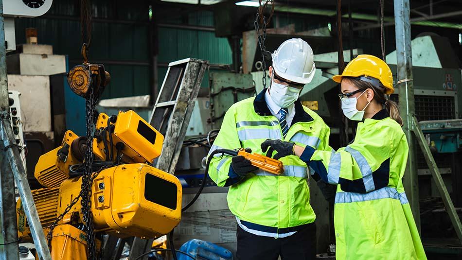 image of workers discussing safety advantages of cnc machines